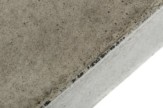 Close-up of a concrete surface with a visible joint between two slabs.