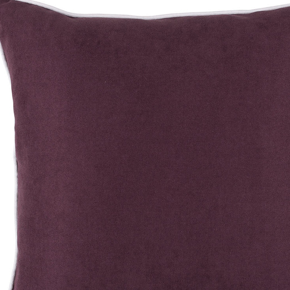 Close-up of a purple pillow with a white border