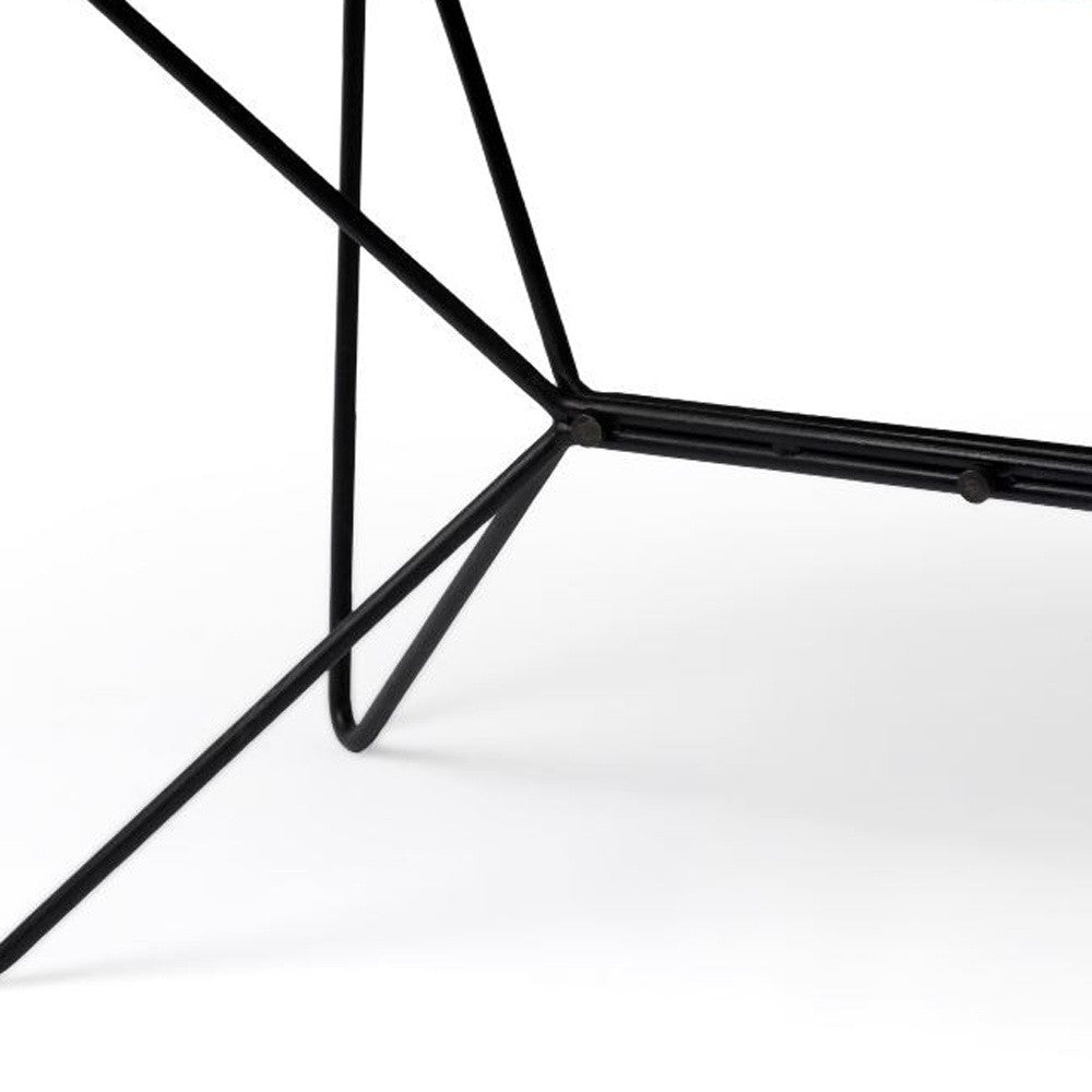 Close-up of a black metal chair frame on a white background