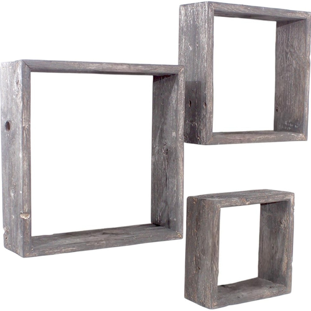Set of three rustic wooden square shelves on a white background