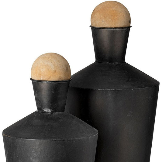 Two black ceramic vases with spherical wooden tops on a white background