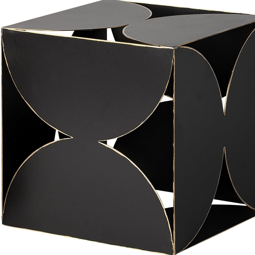 Black geometric side table with gold accents on a white background