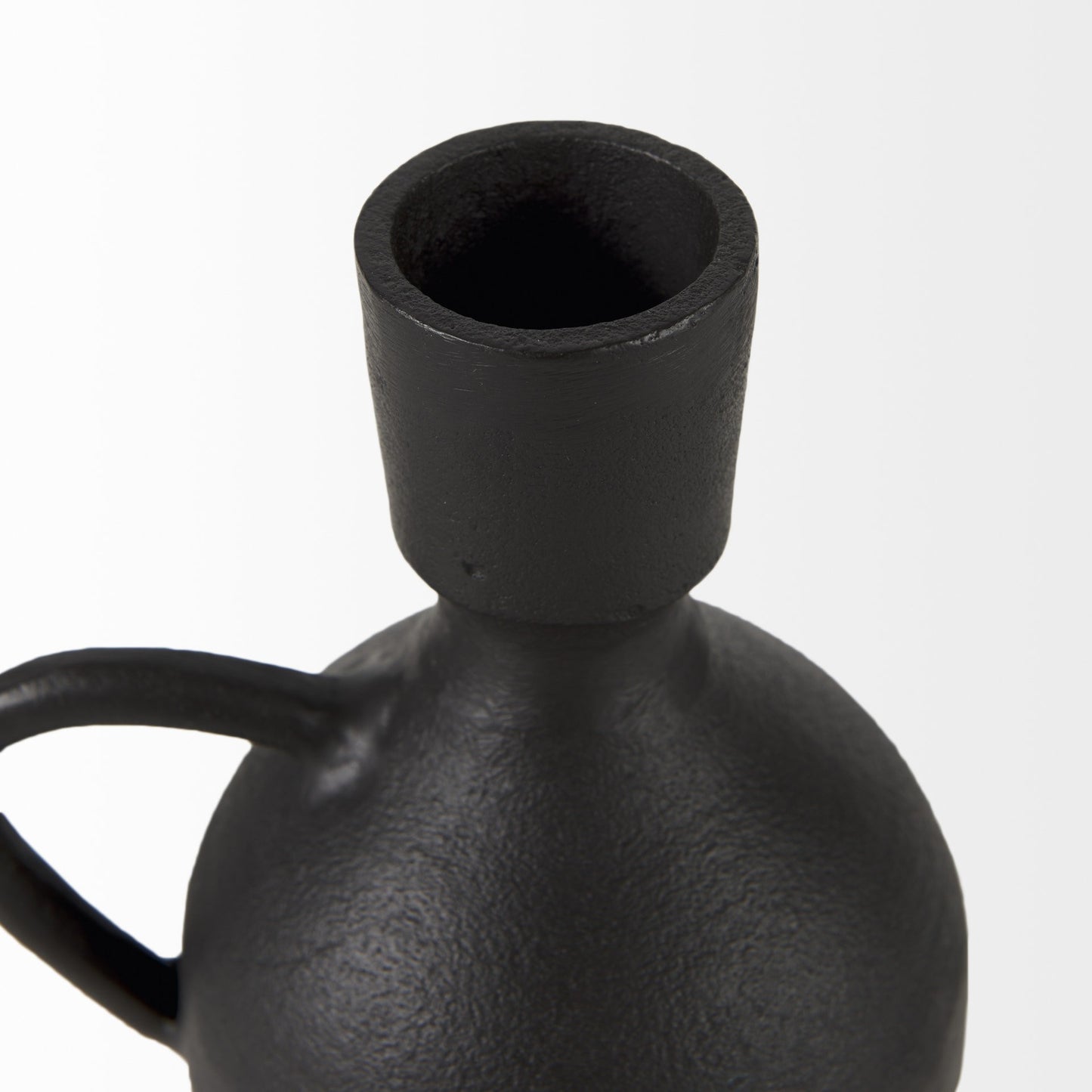 Black ceramic vase with a handle on a white background