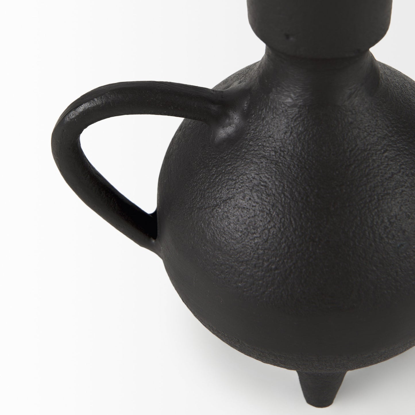 Black ceramic vase with a handle on a white background