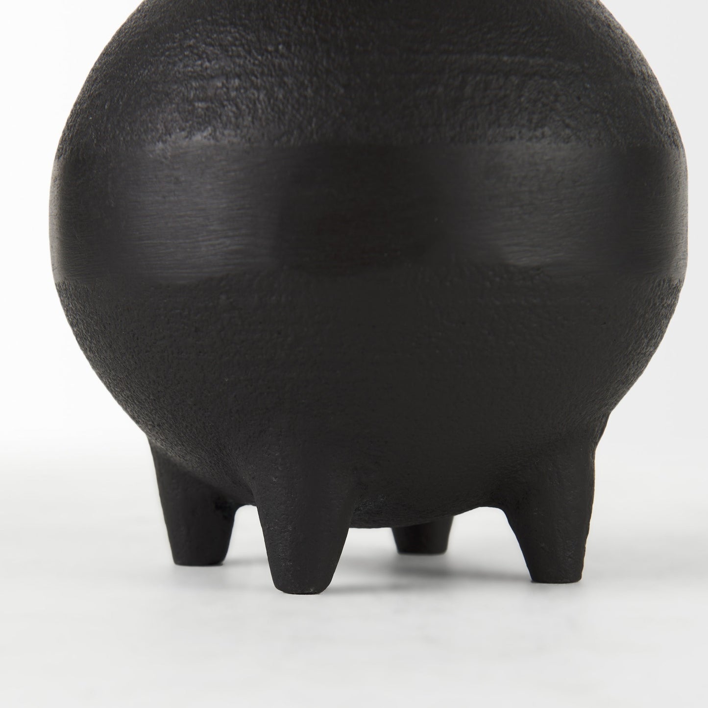 Black ceramic vase with a textured surface on a white background