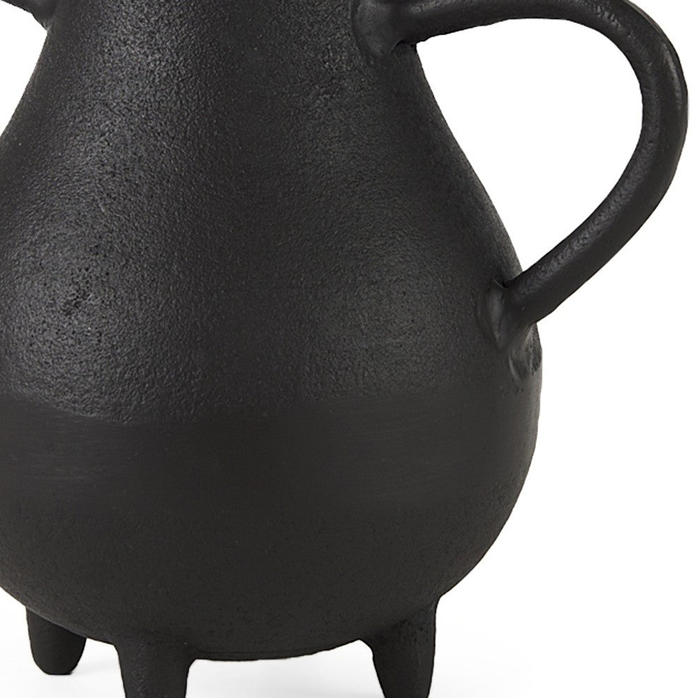 Black ceramic teapot with a handle on a white background