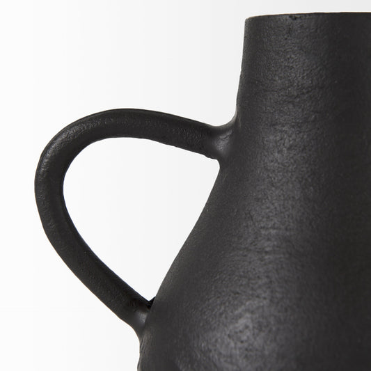 Black ceramic vase with a handle on a white background