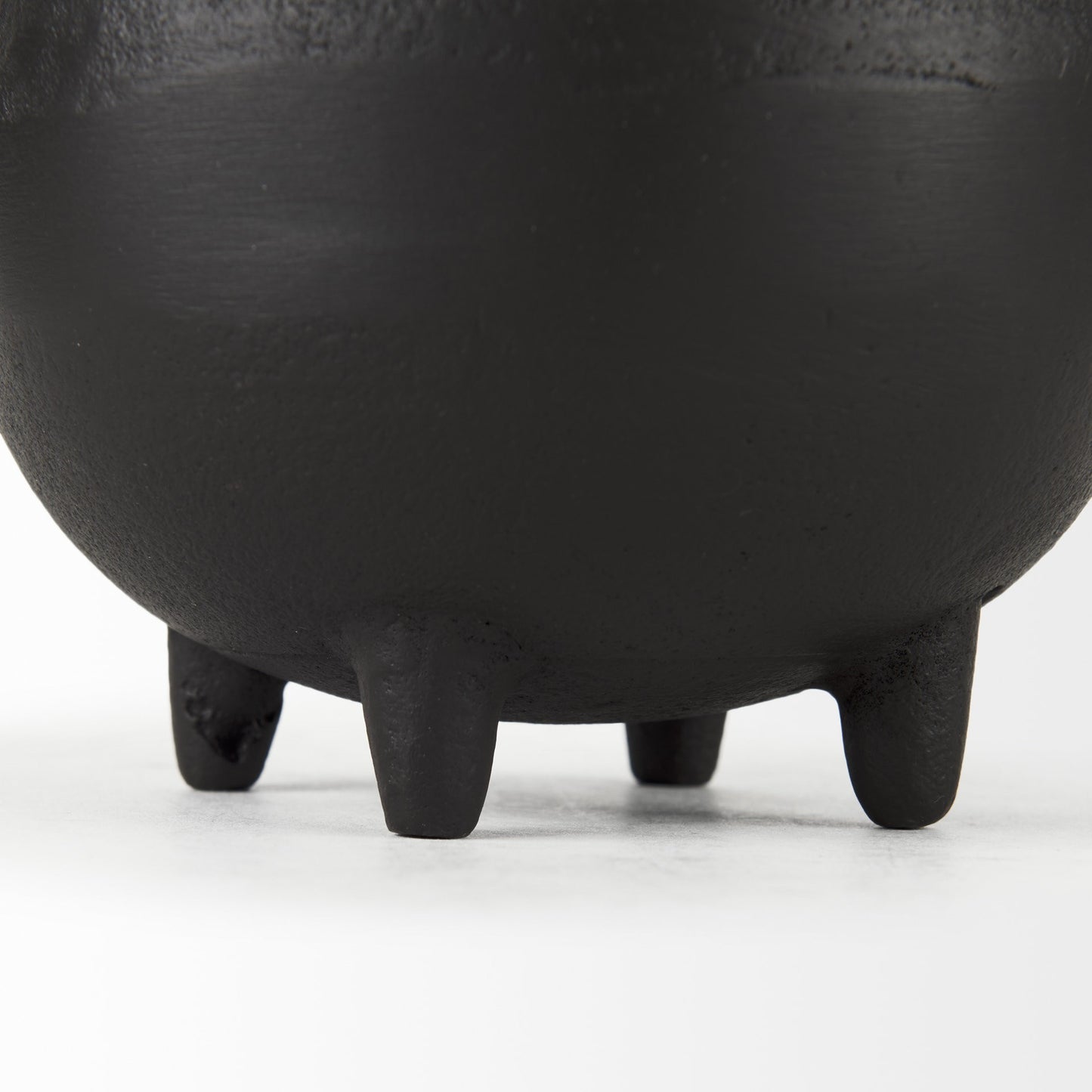 Close-up of a black ceramic pot with a white background