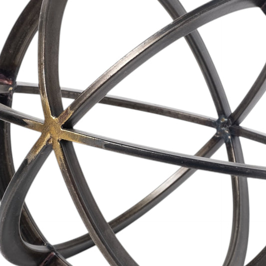 Close-up of a metallic sphere with interlocking rings on a white background