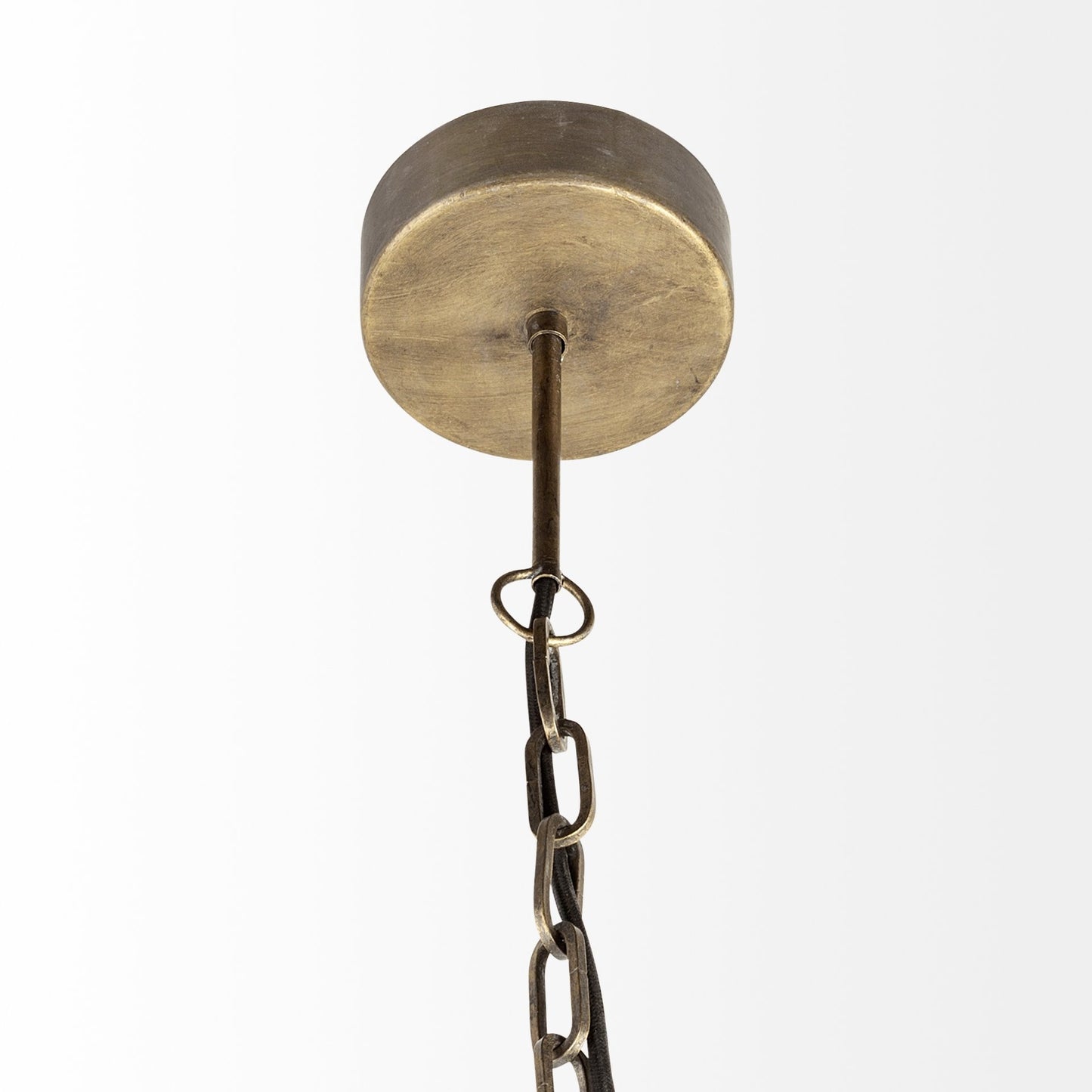 Brass ceiling light fixture with chain on a white background