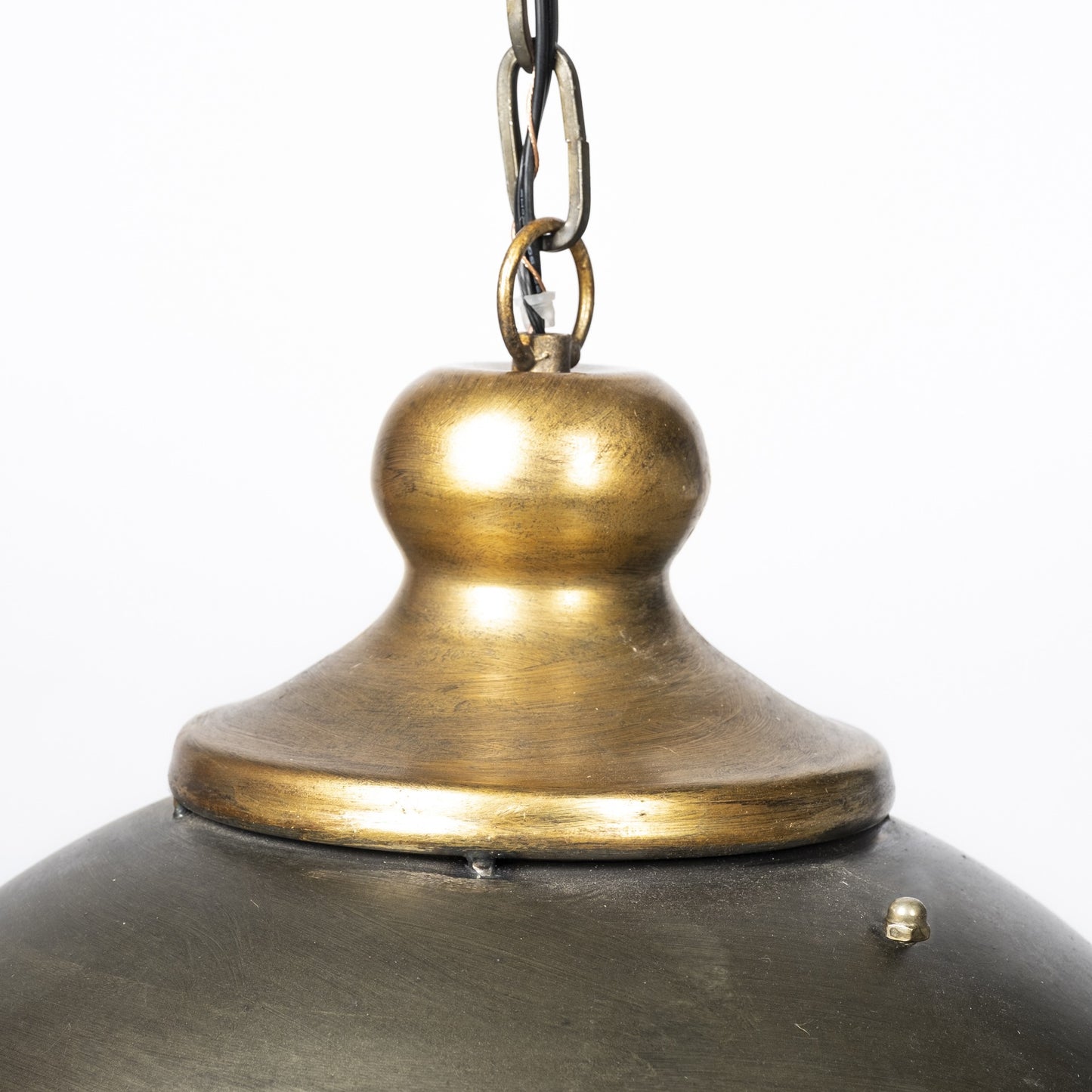 Close-up of a brass pendant light fixture on a white background
