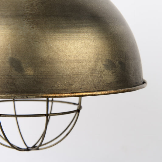Close-up of a brass lampshade with a wire cage on a white background