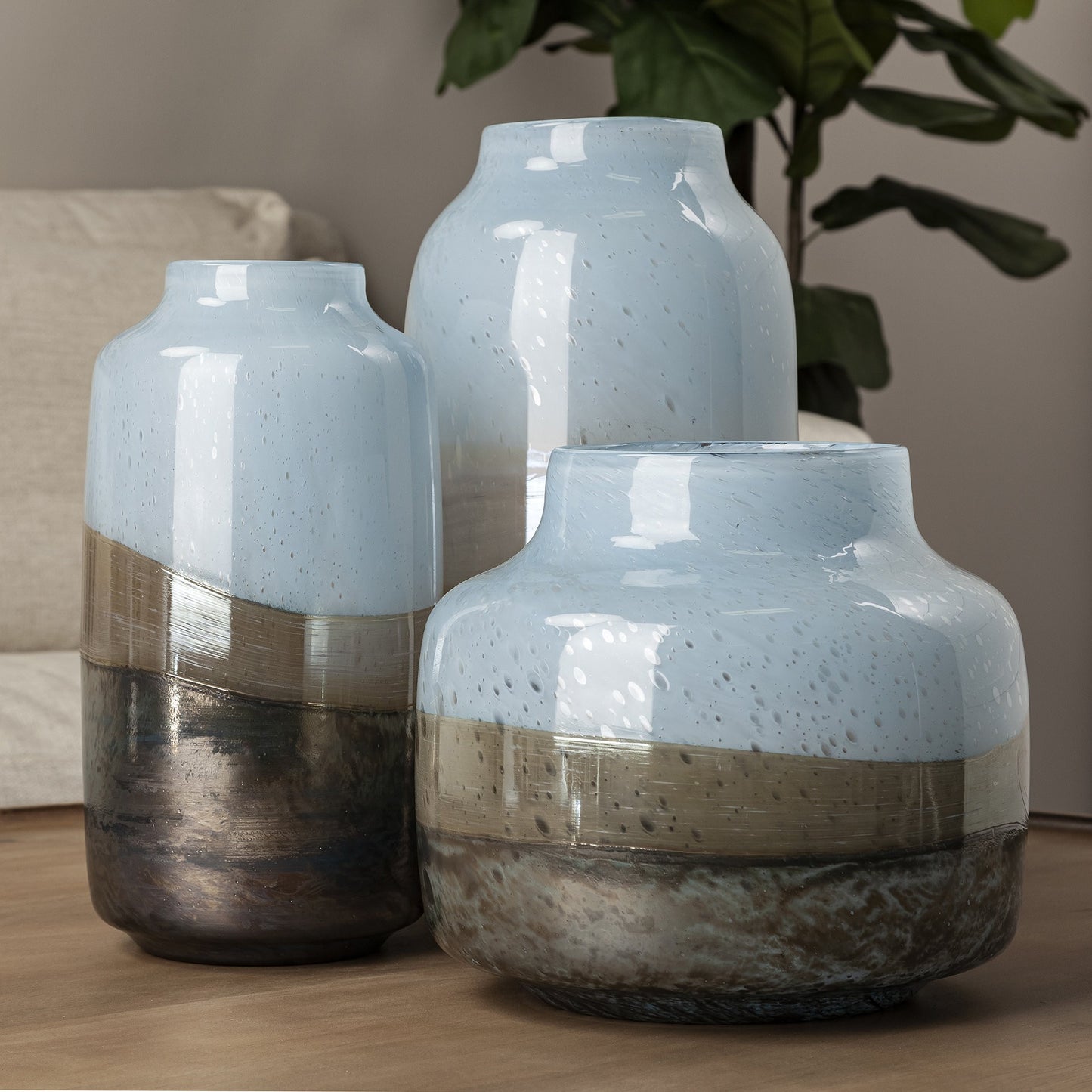 Three Jumbo Wave Pattern Glass Vases in shades of blue, beige, and brown, with a contemporary urn shape and ombre wave pattern.