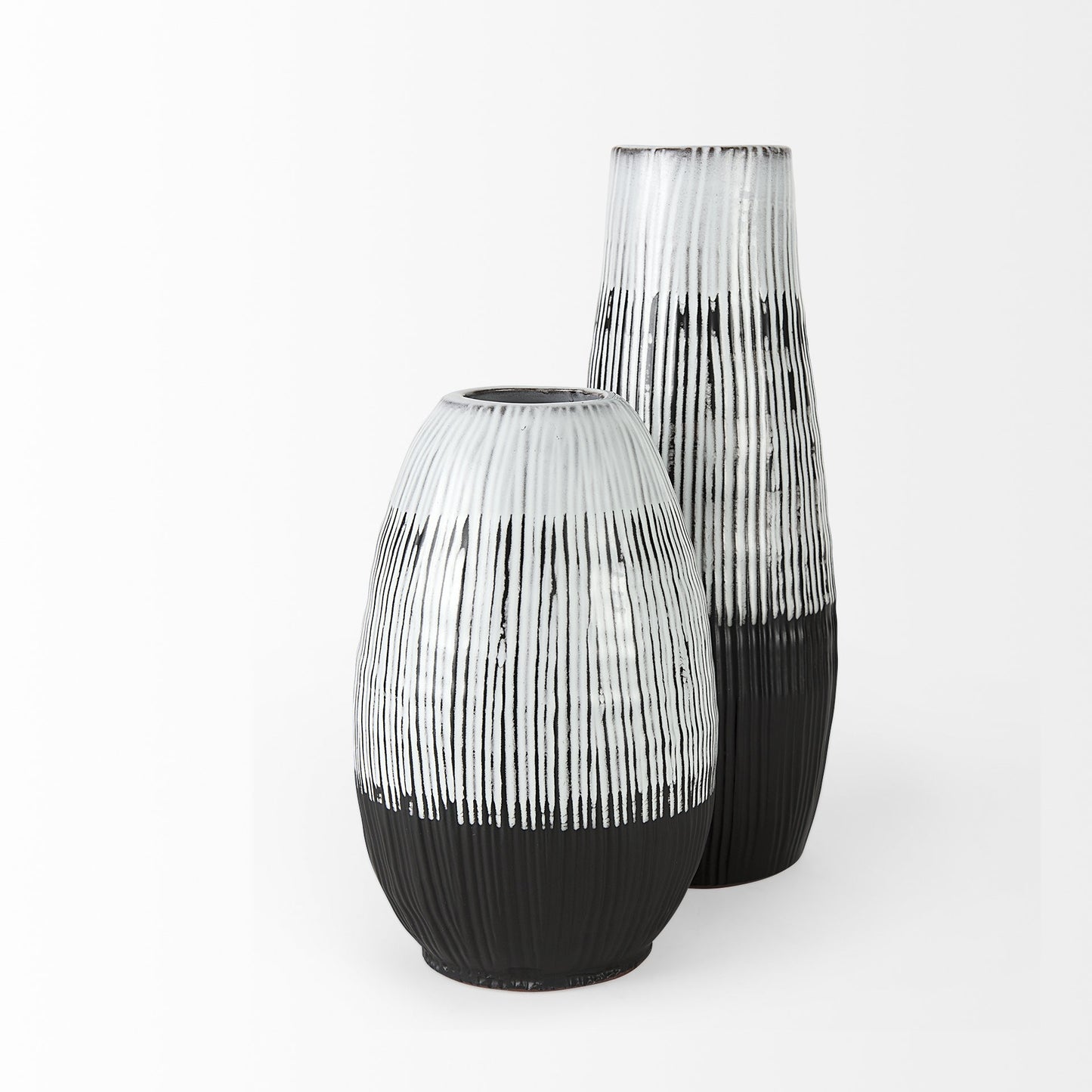 Two black and white patterned vases on a white background