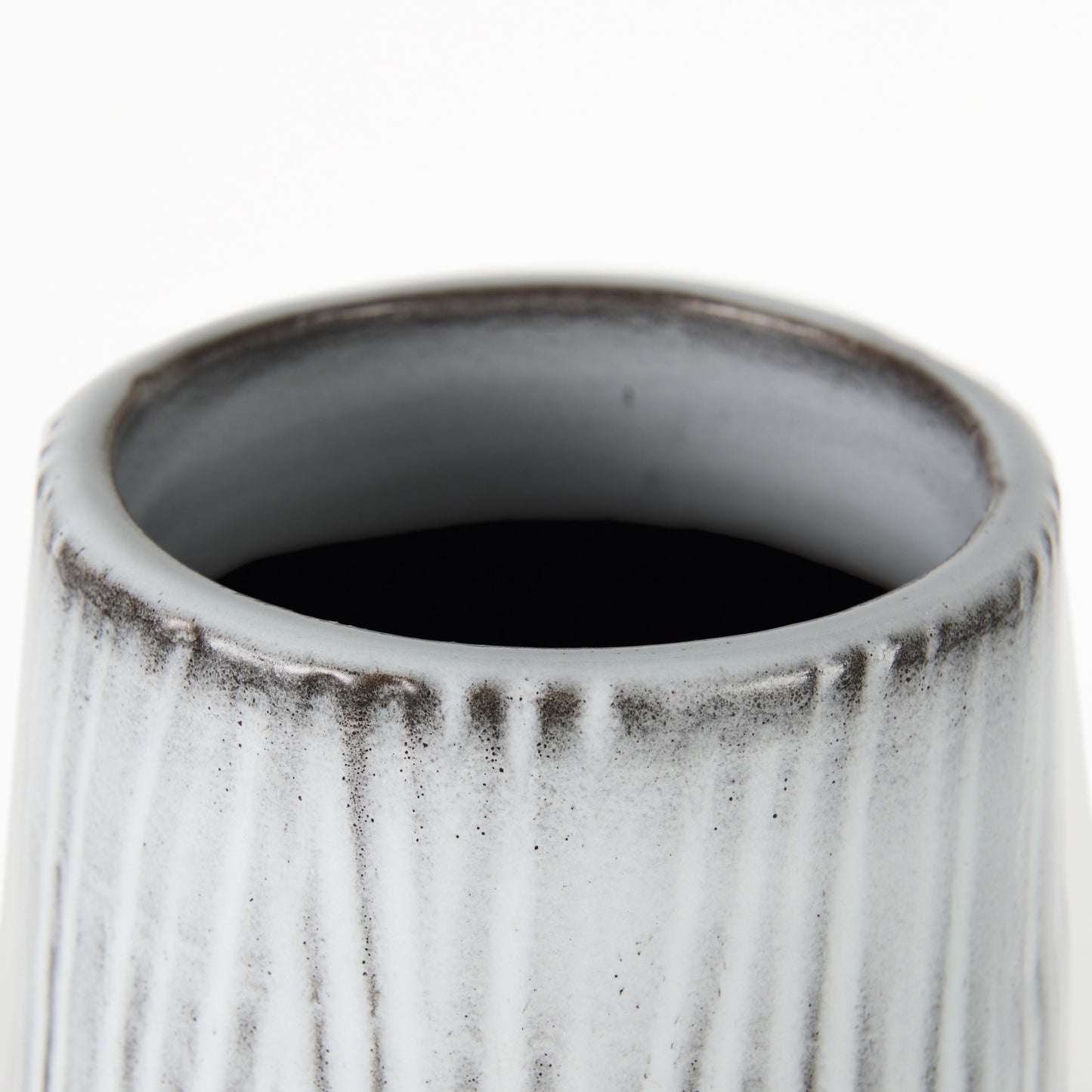 Close-up of a textured ceramic vase on a white background