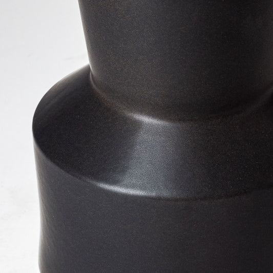 Close-up of a black cylindrical object on a white background