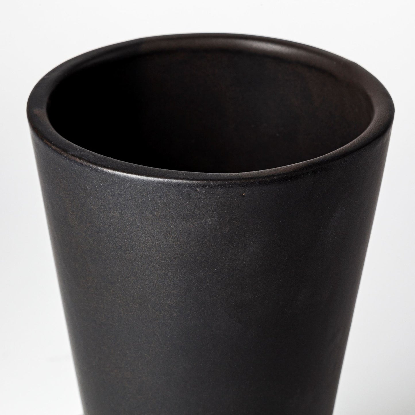 Black ceramic vase on a white background