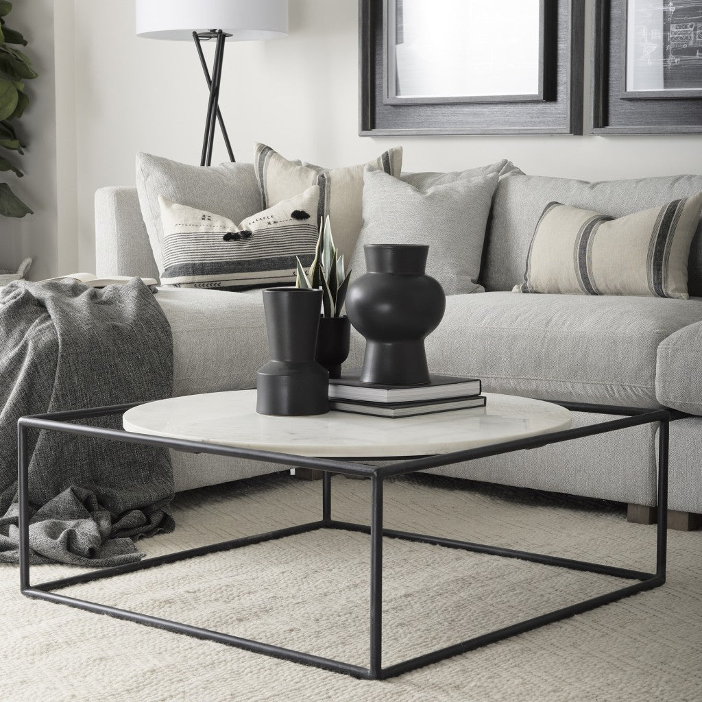 Living room with a gray sofa, coffee table, and decorative items.