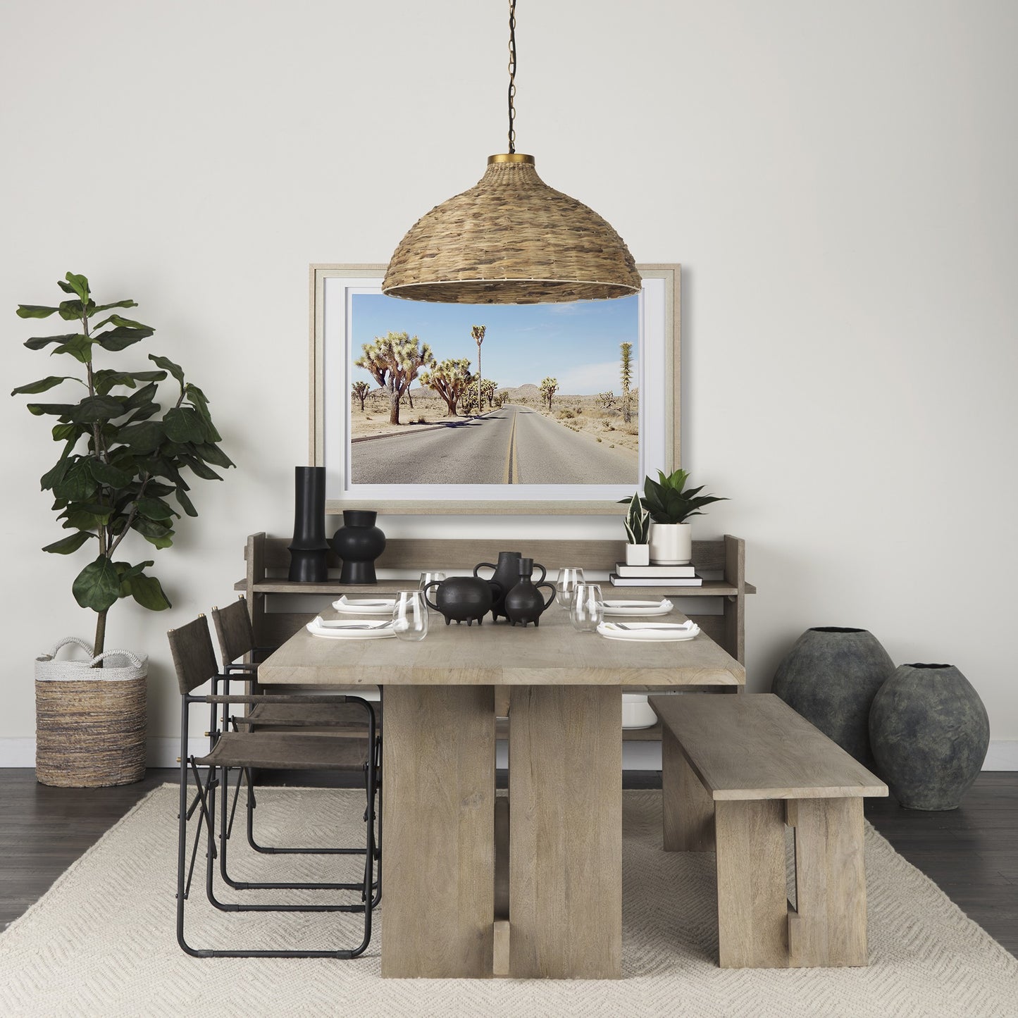 Dining room with wooden table, chairs, and a large framed picture on the wall.