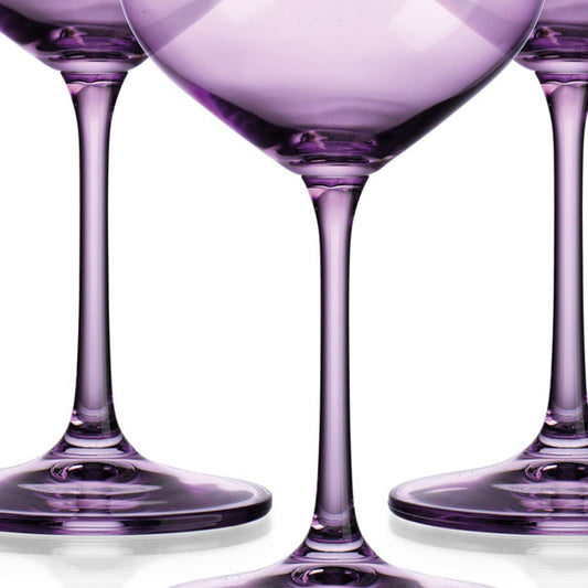Three purple wine glasses on a white background