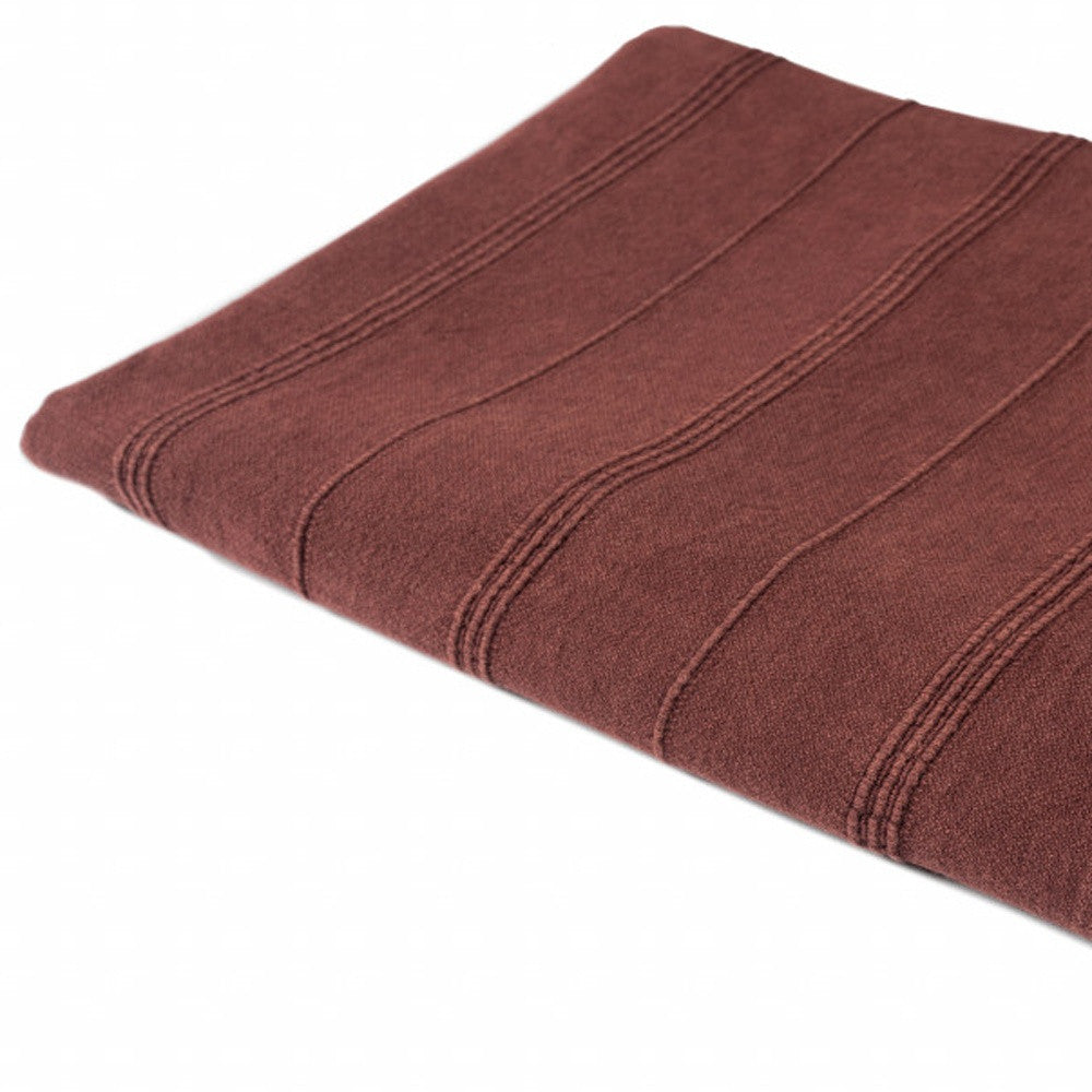 Folded brown towel on a white background