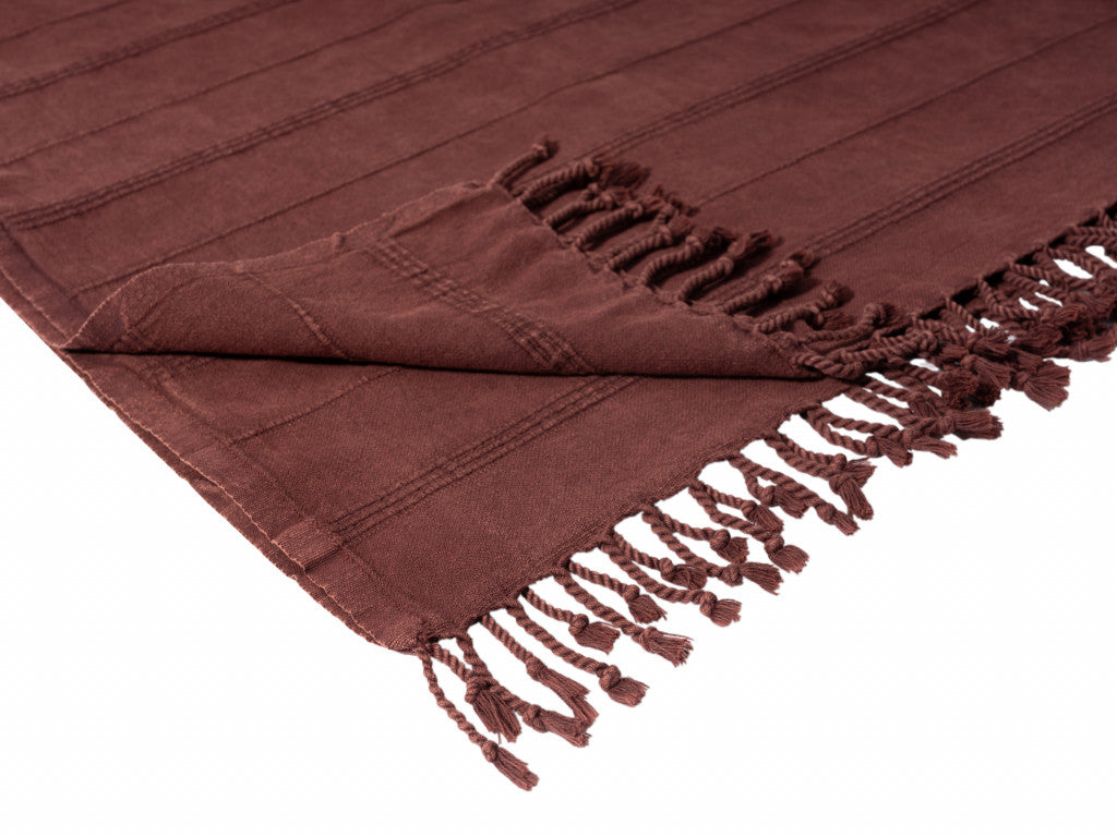Brown towel with fringes on a white background