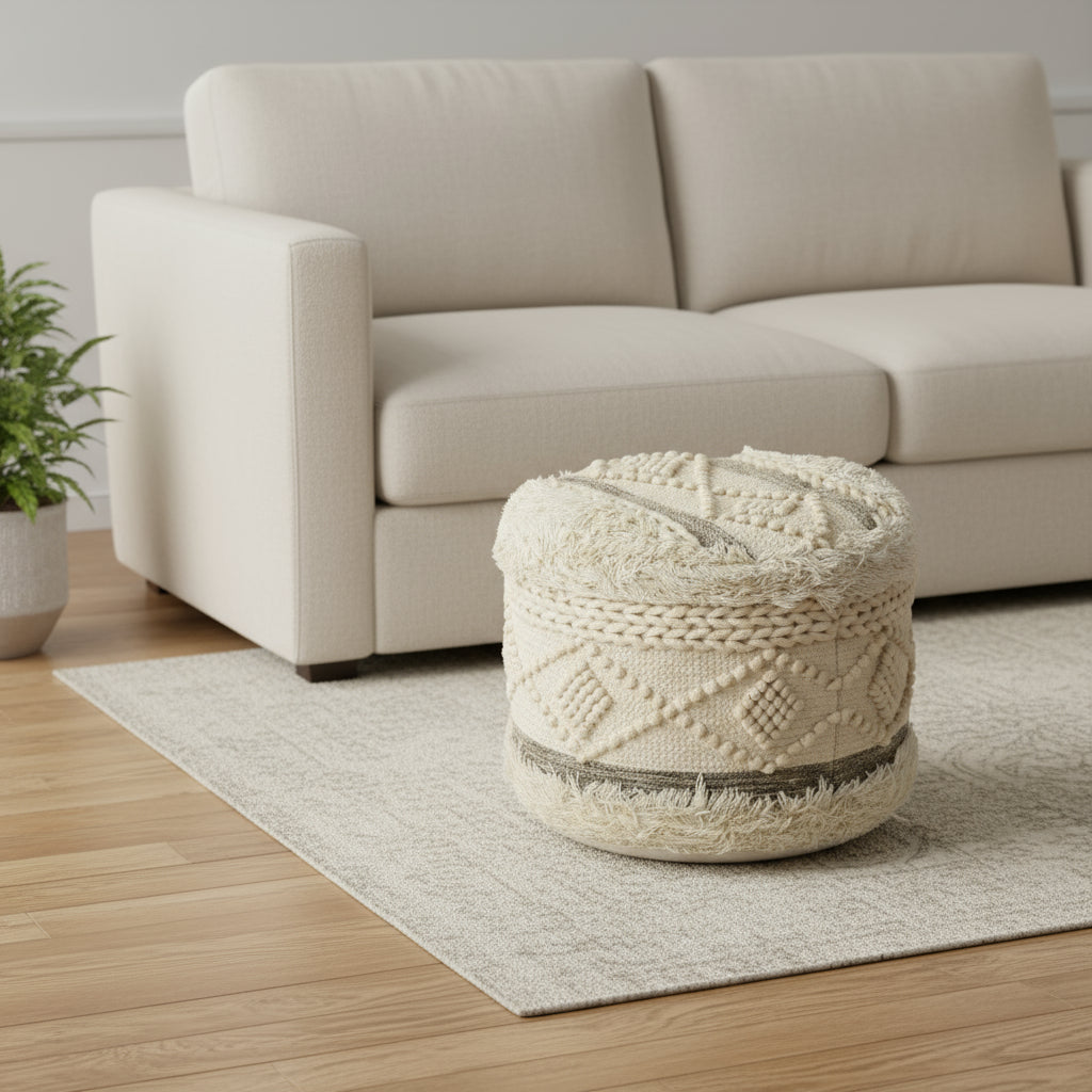 Woven ottoman in a living room setting with a beige sofa and plant.