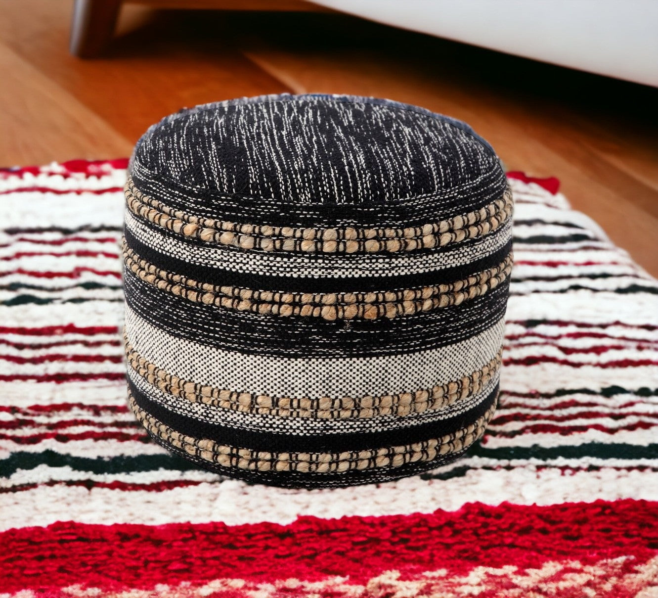 Textured ottoman on a colorful striped rug