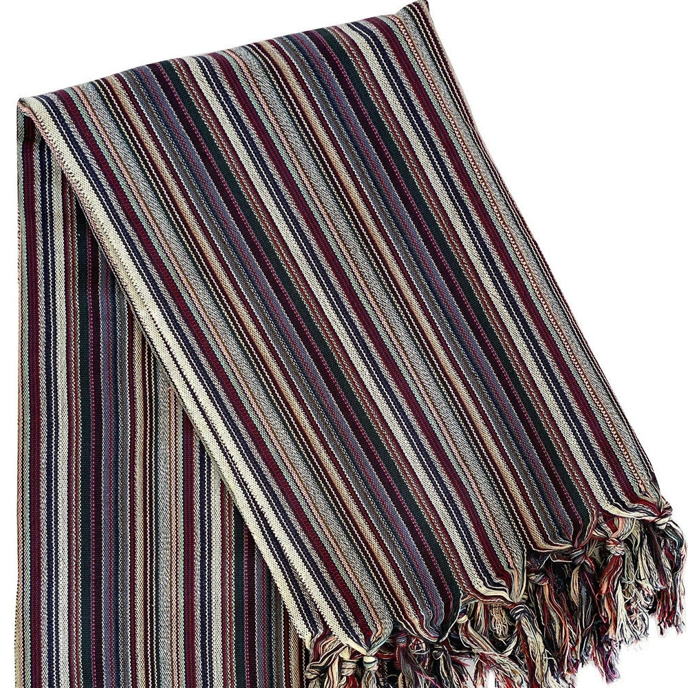 Striped blanket with fringes on a white background