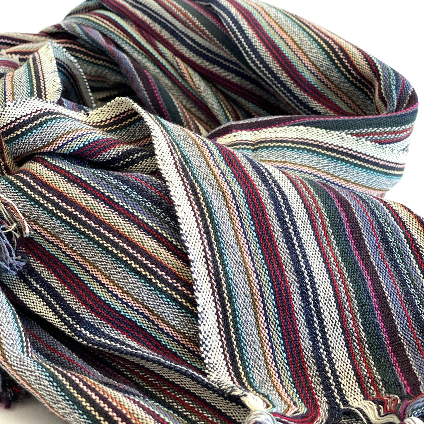 Multicolored striped fabric with tassels on a white background