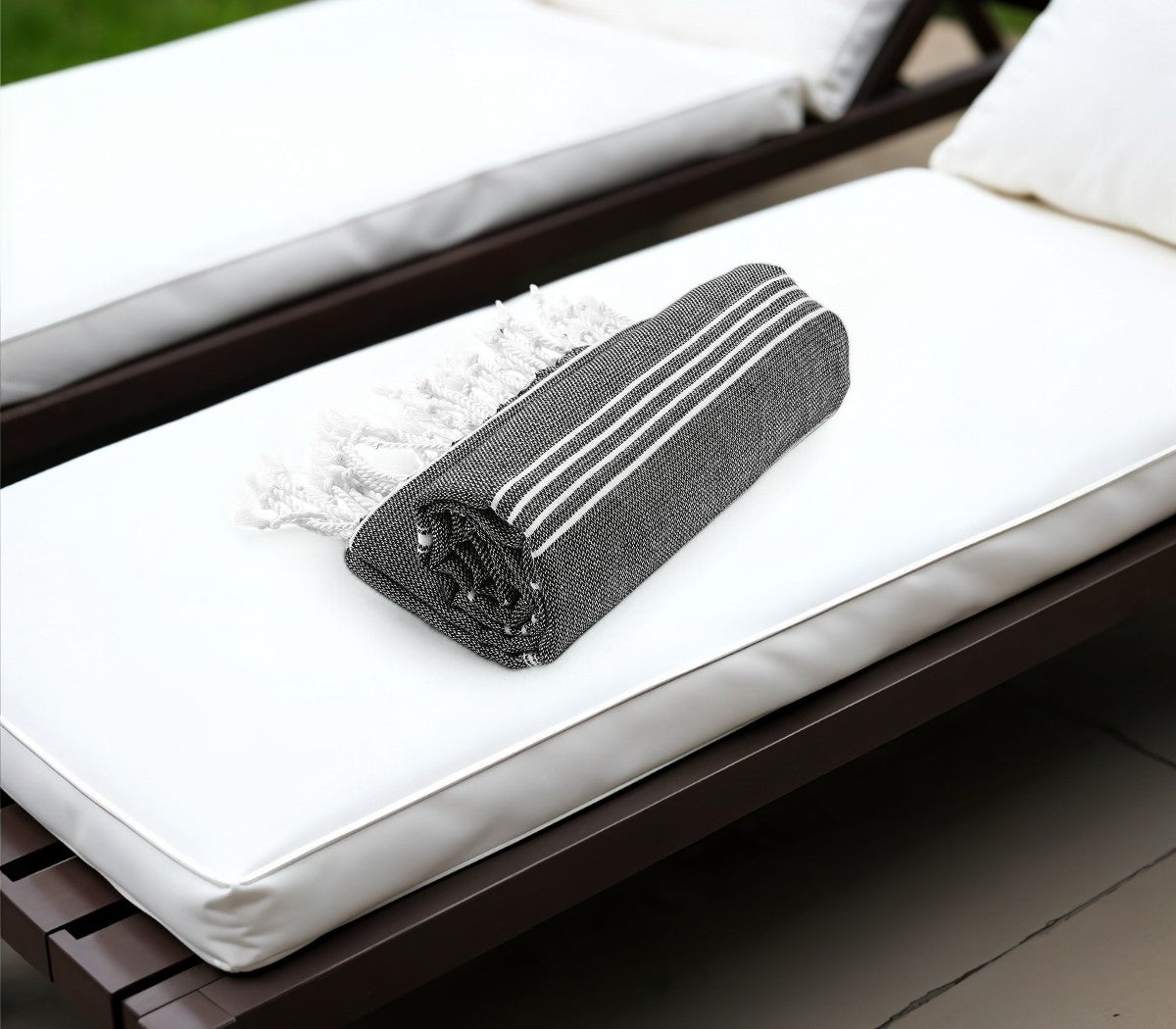 Black textured rectangular object on a white cushioned chair
