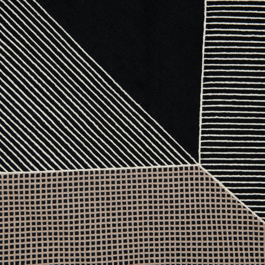 Close-up of fabric with diagonal stripes and grid pattern on a black background