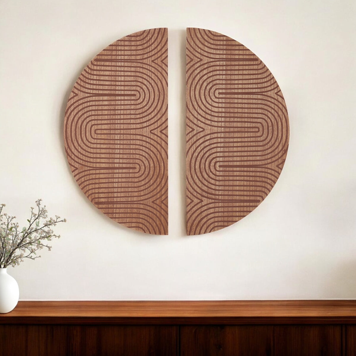 Two circular wooden wall art pieces with wavy line patterns on a white wall.