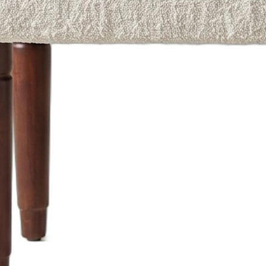 Distressed mango wood leg detail on the Palisades boucle bench