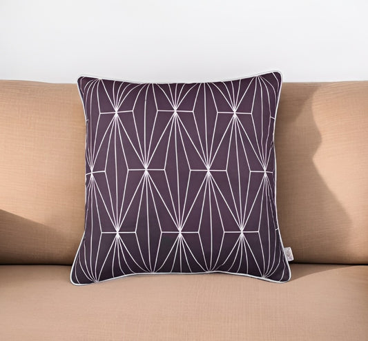 Decorative pillow with geometric pattern on a beige couch