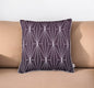 Decorative pillow with geometric pattern on a beige couch