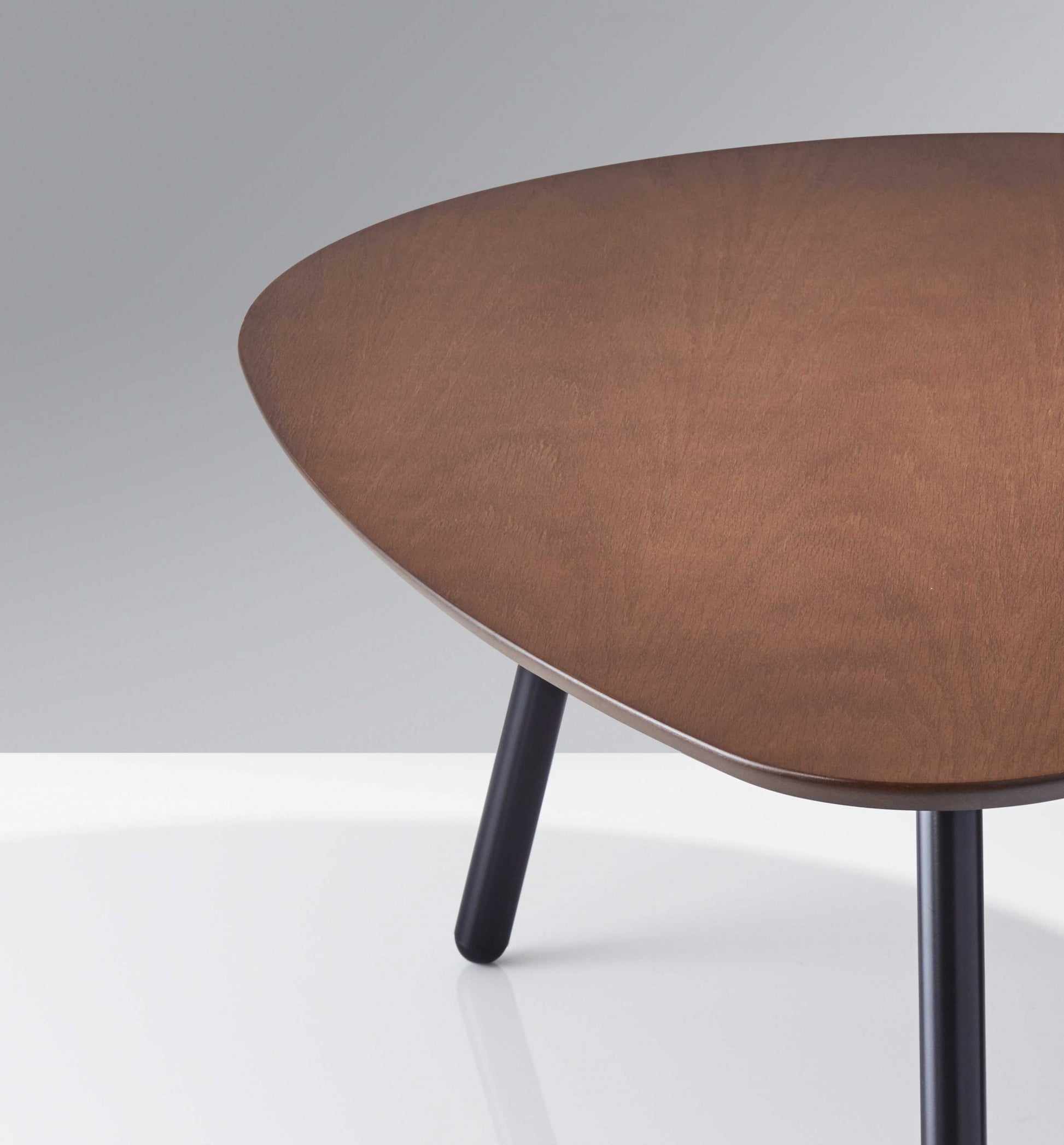 Wooden table with three legs on a white background