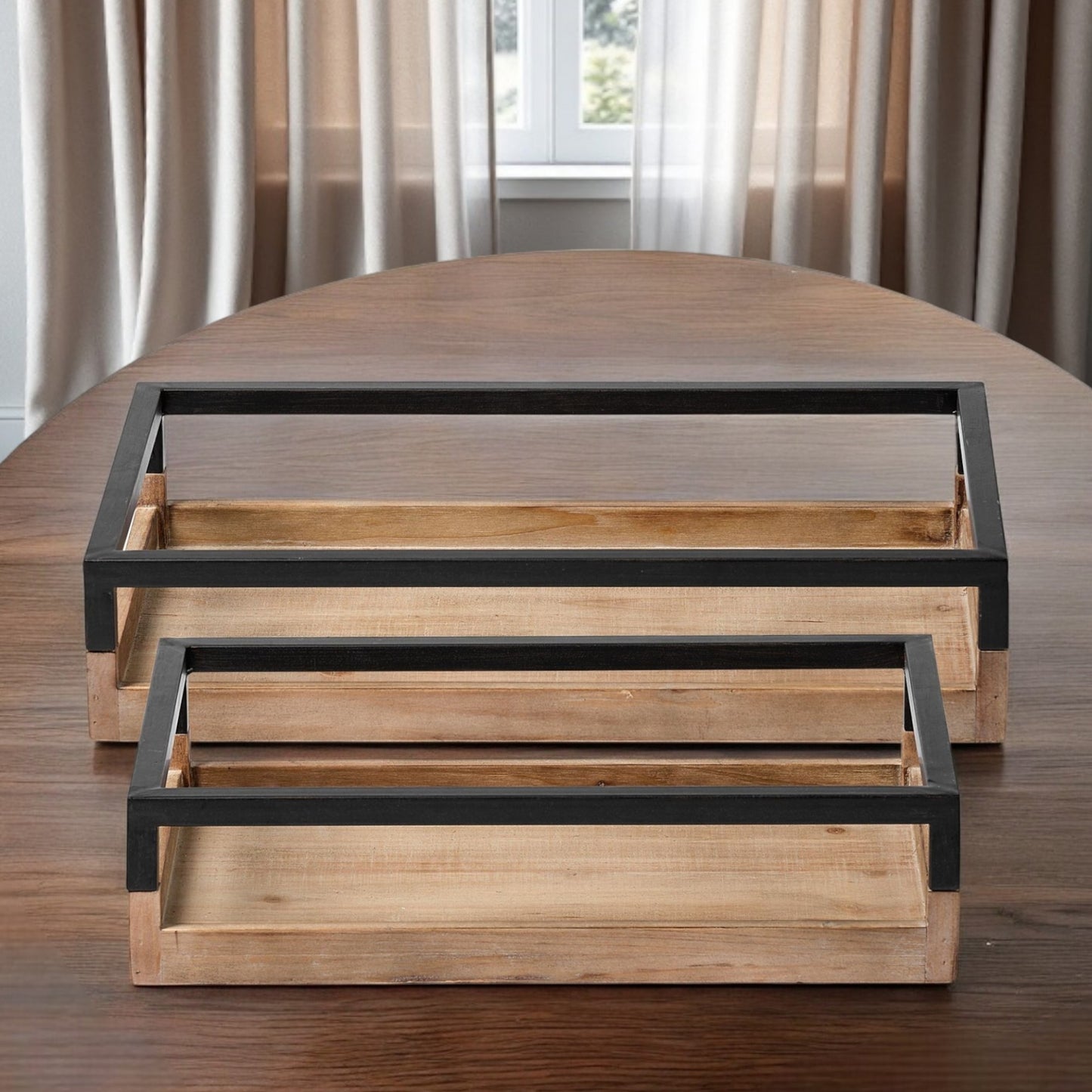 Set of two wooden trays with black metal frames on a wooden surface.