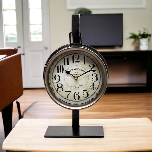 Vintage-style table clock on a stand in a room with furniture and decor.