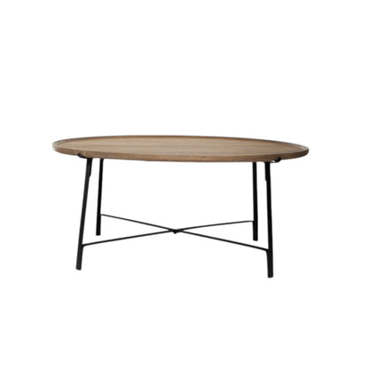 Round wooden table with black metal legs on a white background