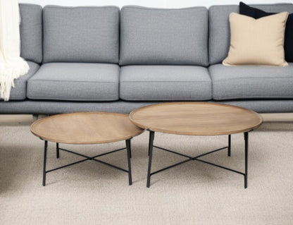 Gray sofa with two wooden coffee tables in a living room setting