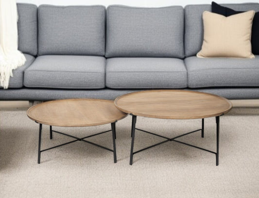 Gray sofa with two wooden coffee tables in a living room setting