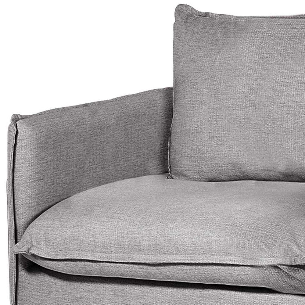 Gray fabric sofa with a pillow on a white background