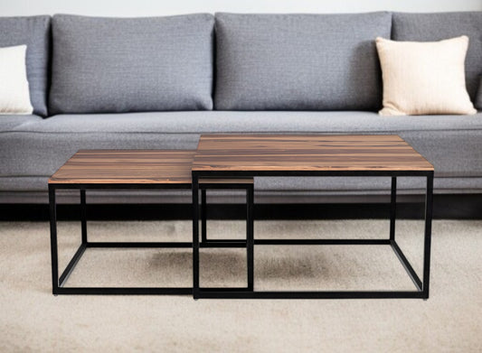 Two wooden coffee tables with metal frames in front of a gray sofa.