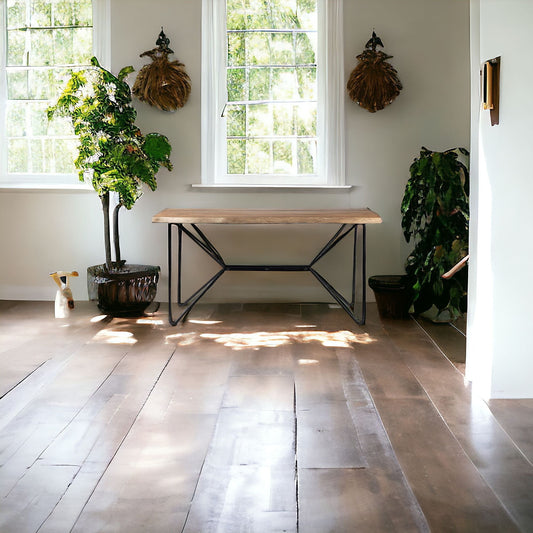 Wooden table in a room with large windows and plants