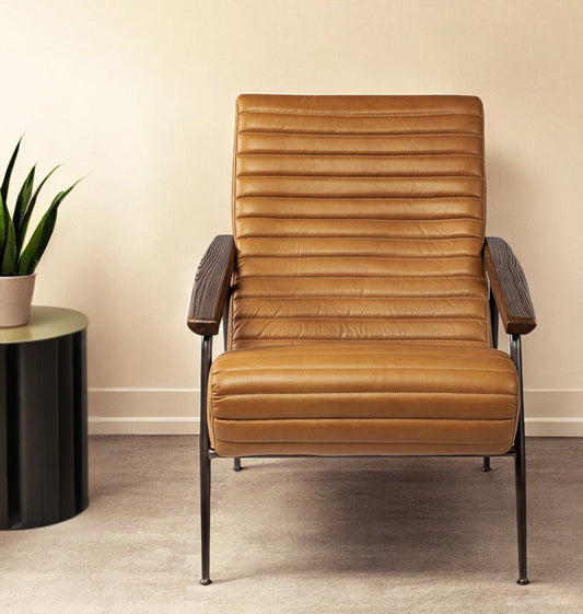Brown leather armchair with black metal legs in a room setting.
