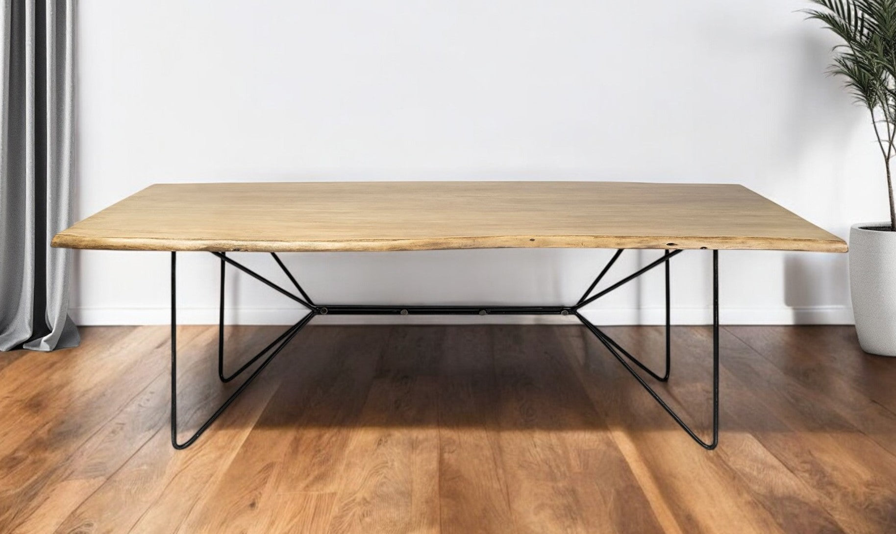 Wooden table with black metal legs on a wooden floor