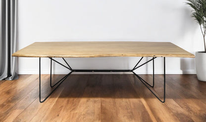 Wooden table with black metal legs on a wooden floor