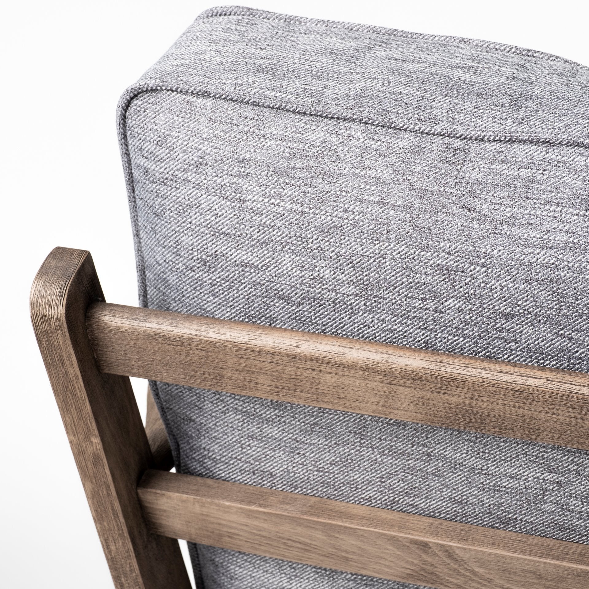 Close-up of a gray cushioned chair with wooden slats on a white background