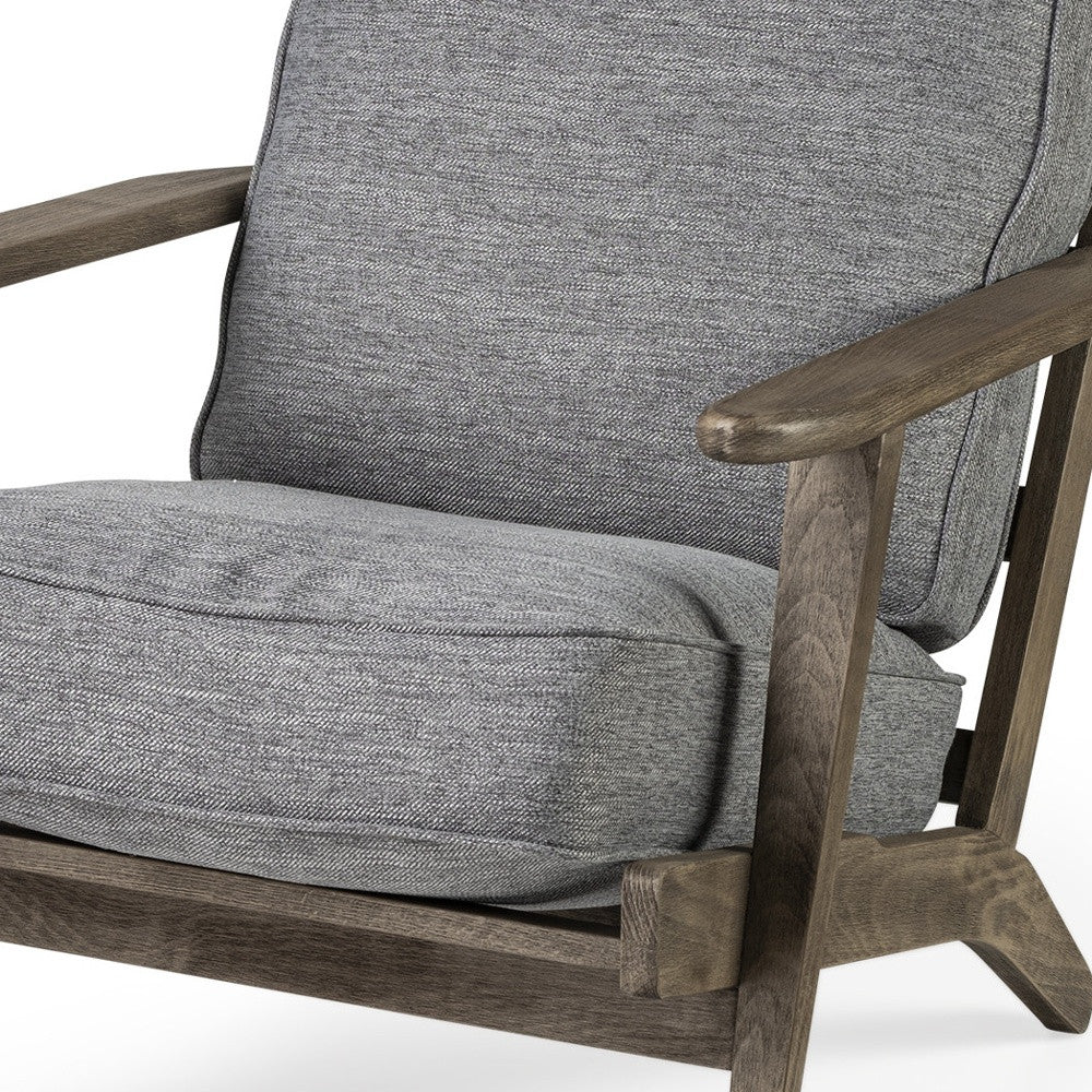 Gray upholstered chair with wooden armrests on a white background